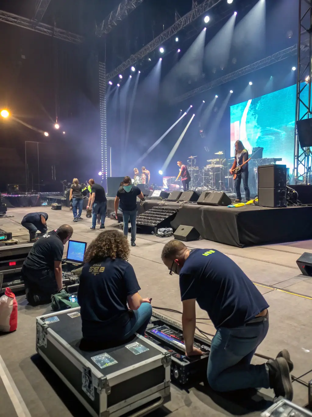 An image of volunteers setting up for a community music event, showcasing the collaborative spirit of ASSOCIATION LA PETITE FABRIQUE MUSICALE.
