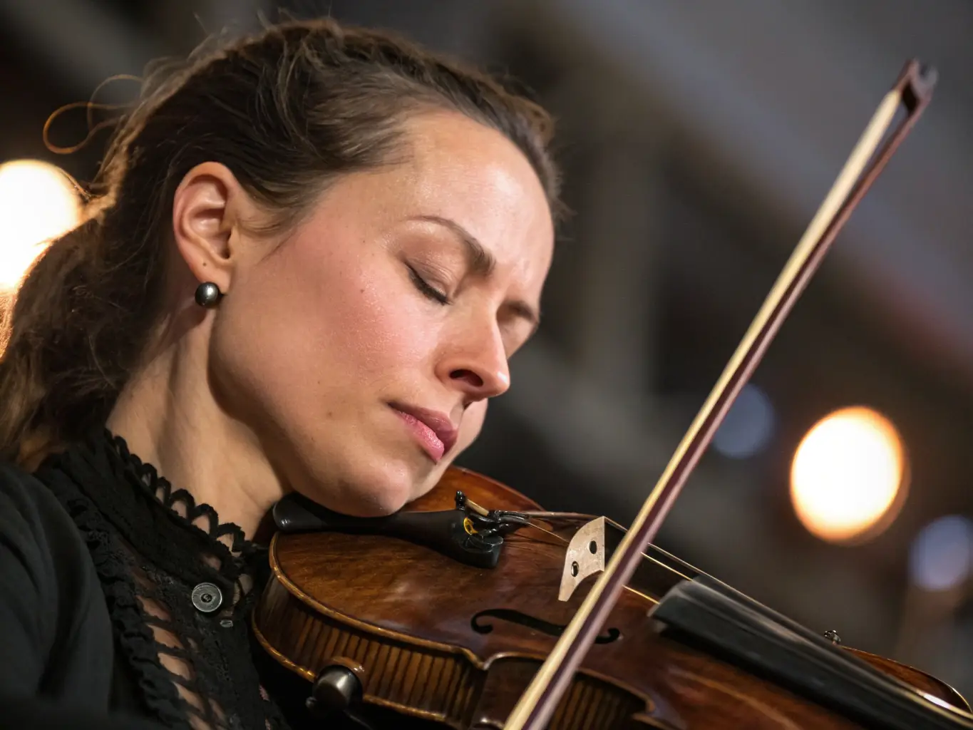A close-up shot of a young musician passionately playing a string instrument, capturing the emotional depth and personal expression that music allows.